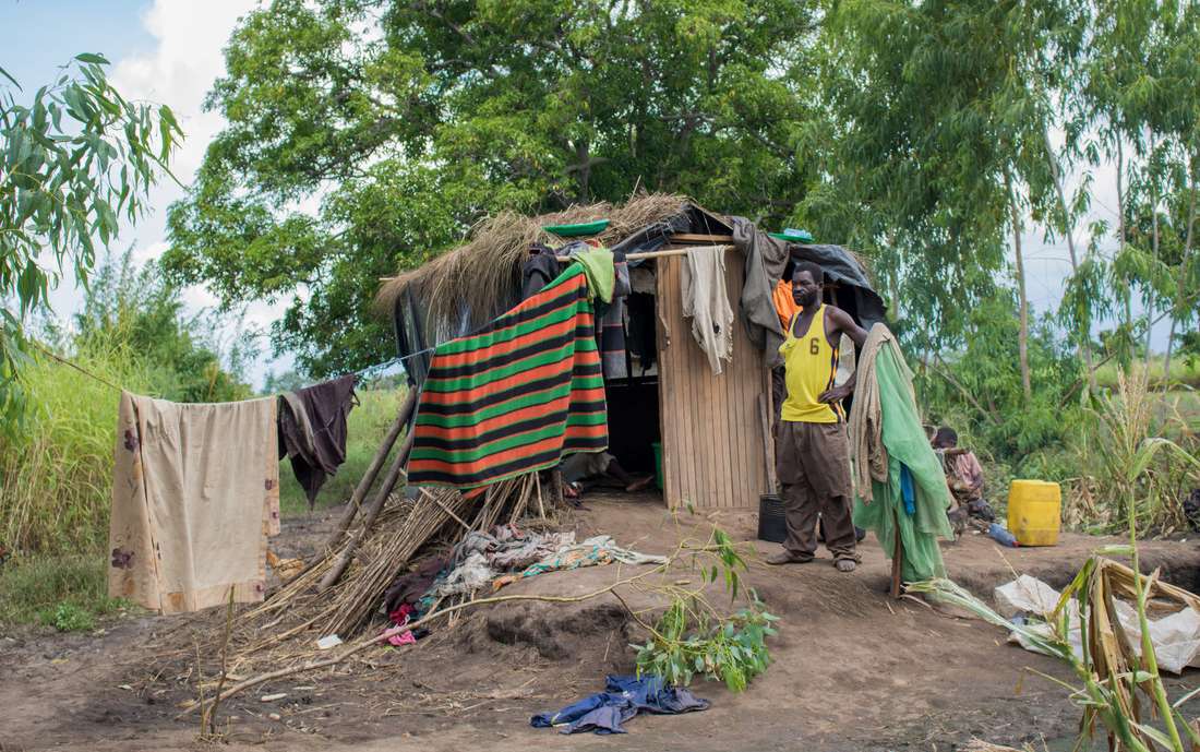  John with temp shelter in Malawi 