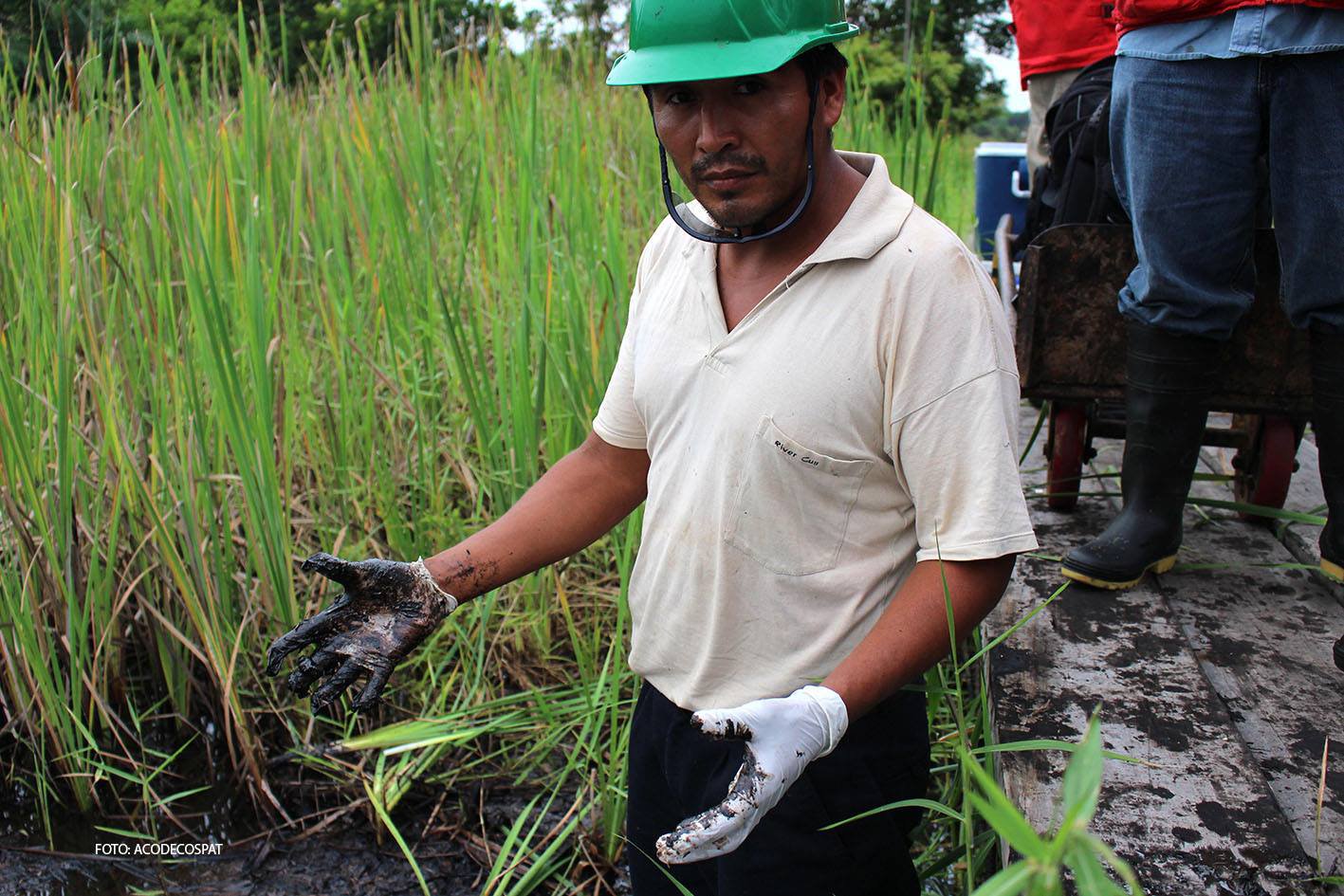 Ander Ordoñez, a monitor with the Peruvian Assessment and Environmental Control Agency, examines the impact of oil spills inside the Marañon river basin in 2013.
