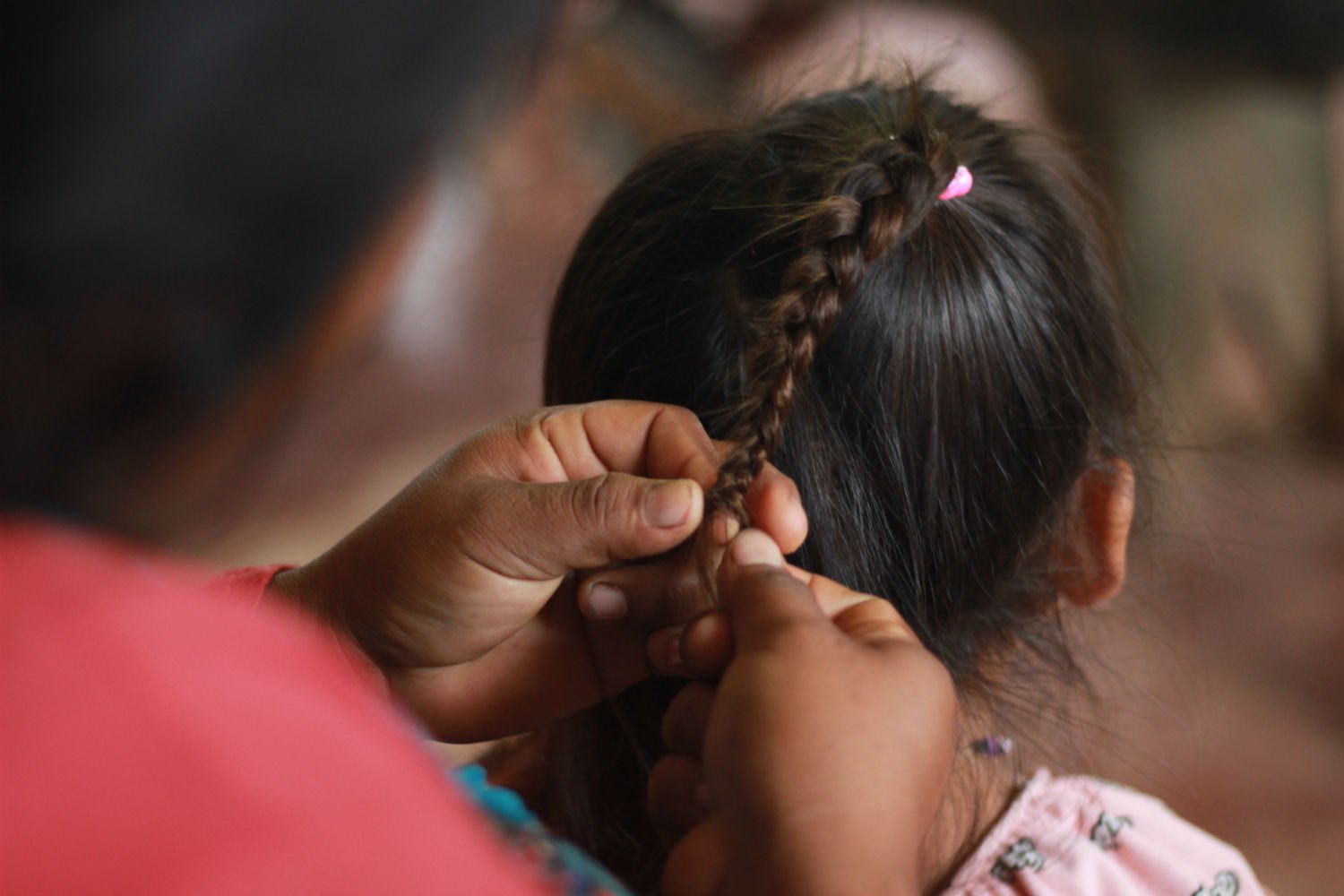 An Achuar mother from the community of Jose Alaya in the Corrientes river basin braids her daughter's hair.