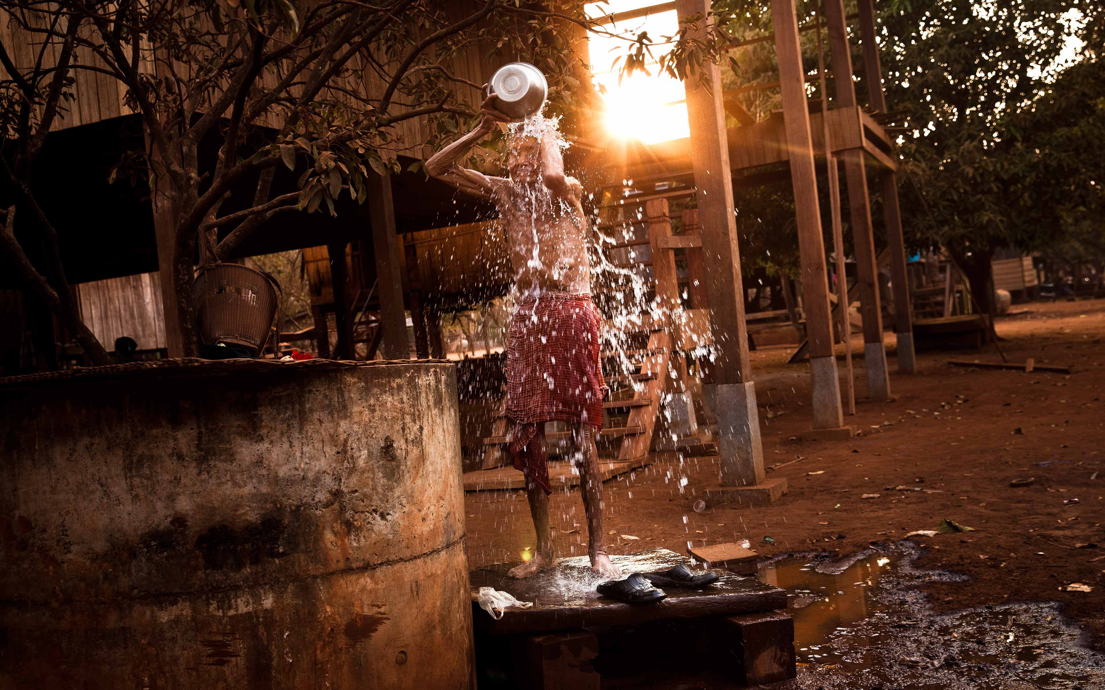 An elderly man bathes at the village well in Kanat Thom. Indigenous people in Cambodia are some of the most impoverished in the country. Though they consider their forest lands sacred, their government and foreign investors see only the money that can be made from those lands.