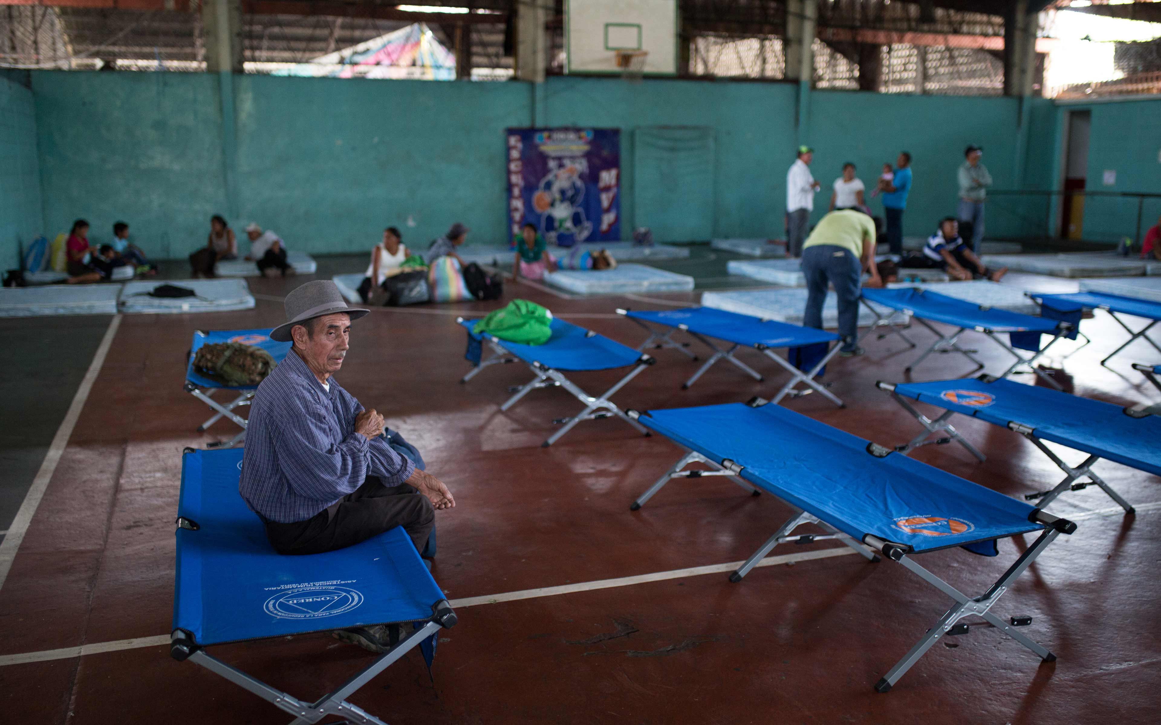 Gervasio López, 83, was assigned this cot in a temporary shelter at the gymnasium in Escuintla. He survived the war, nearly two decades as a refugee in Mexico, and then worked to build a new community in La Trinidad.