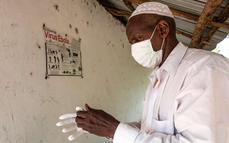 guinea-bissau-ebola-prevention-man-gloves-community-worker-ous-50905.jpg