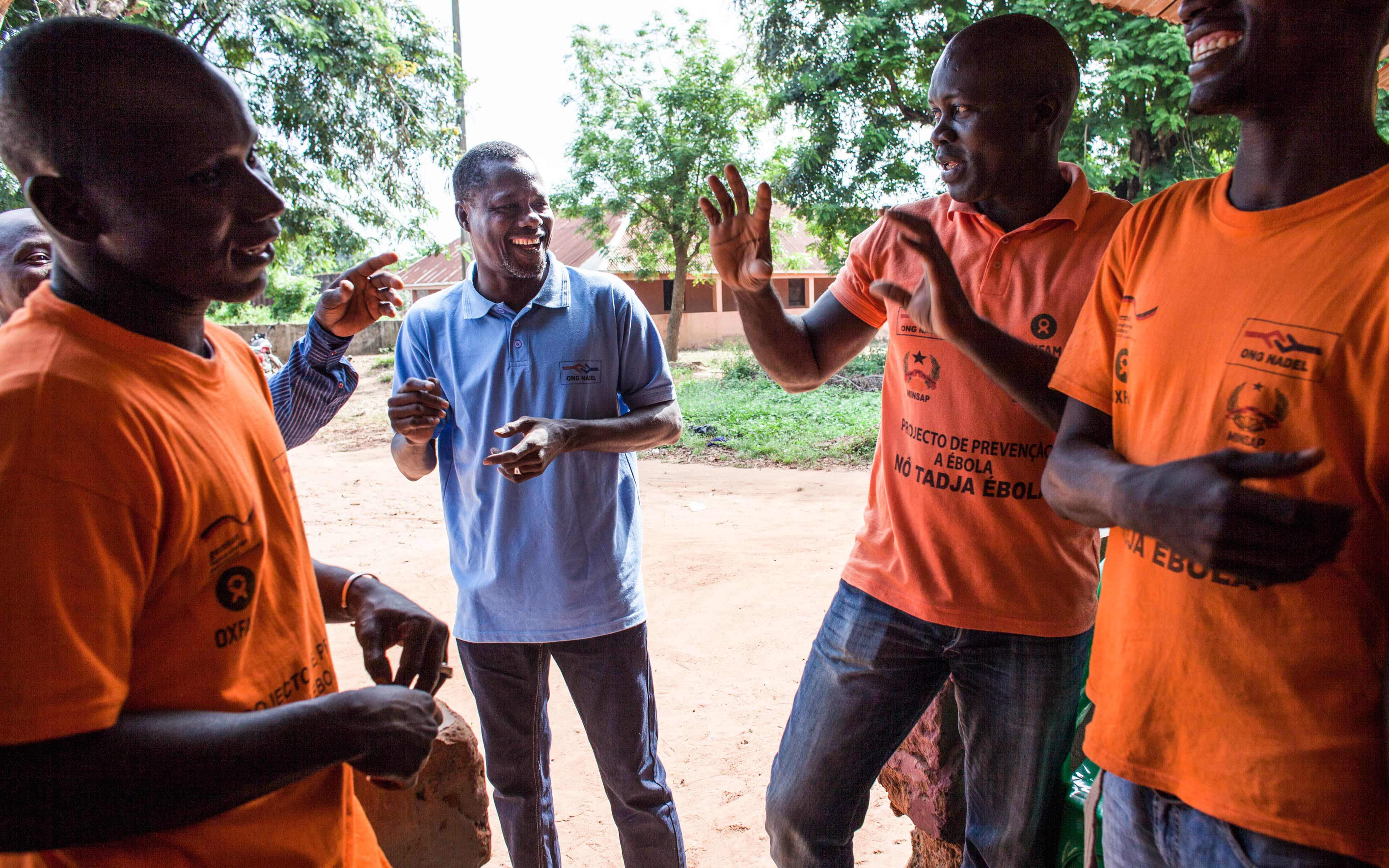 Sidi Jaquité talks with members of his Ebola rapid-response team in Catio, Guinea-Bissau. During the epidemic, the team deployed to communities that were slow to recognize the urgent need for Ebola preparedness measures—living in tents until they were satisfied the job was done.
