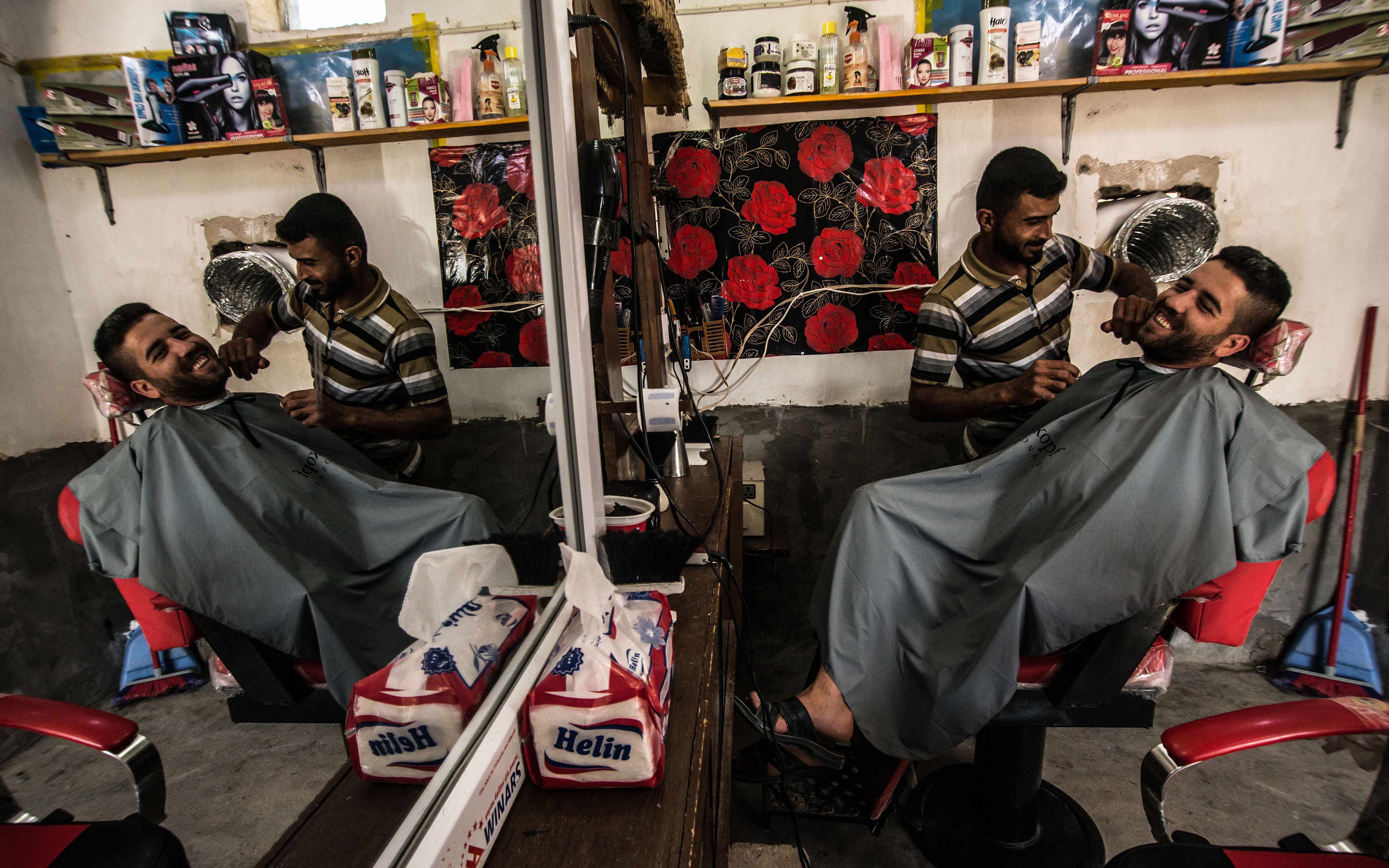Qassim Daoud, whose name has been changed for his protection, was able to restart his barber shop with help from Oxfam. The shop was looted by ISIS in 2014 when it took over the village. The community has now been reclaimed and Daoud is happily back at work.