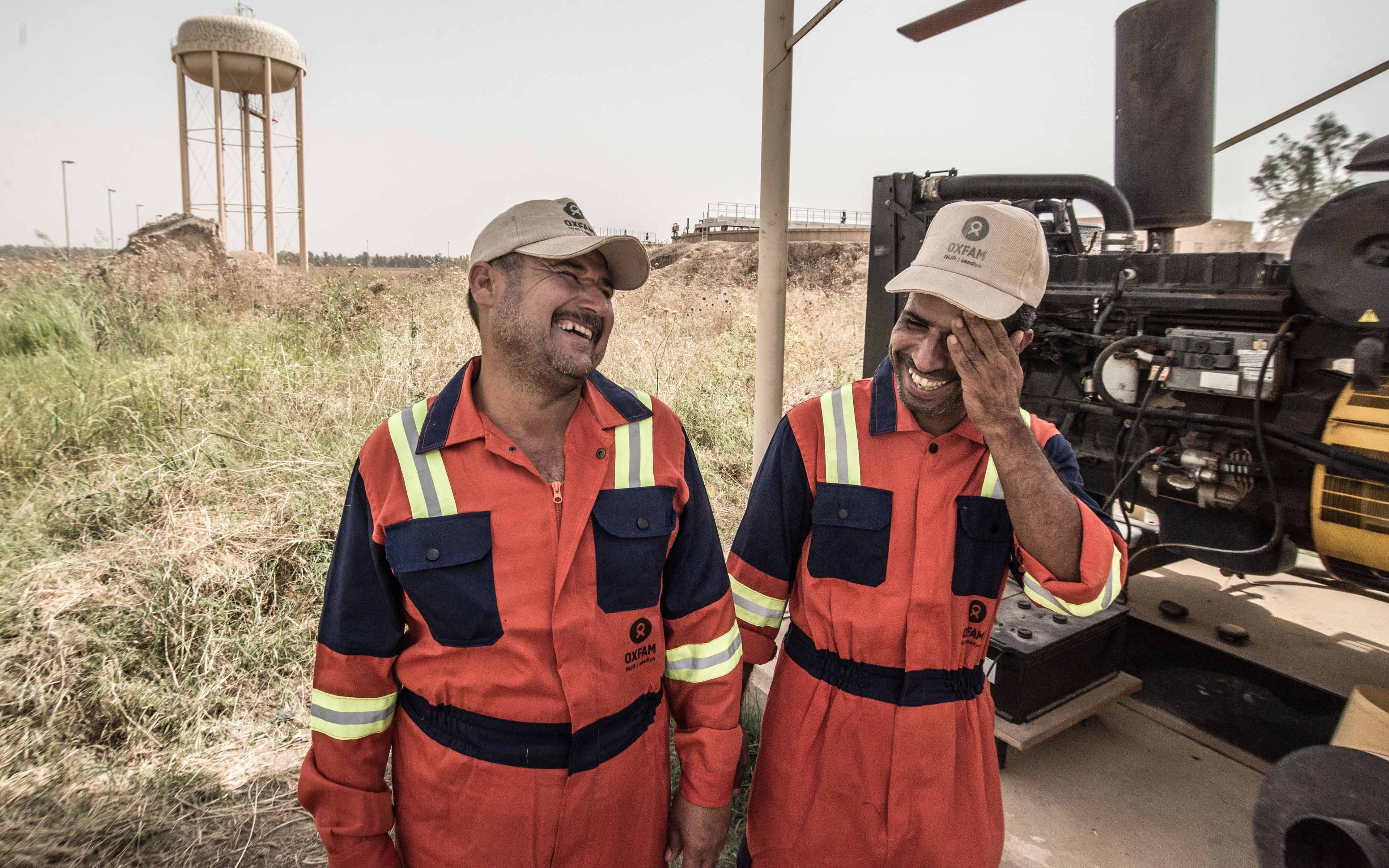 Two staffers from the local water plant in the Iraqi community of Saadiya share a laugh. They were among the first to return after the town as reclaimed following an ISIS occupation.