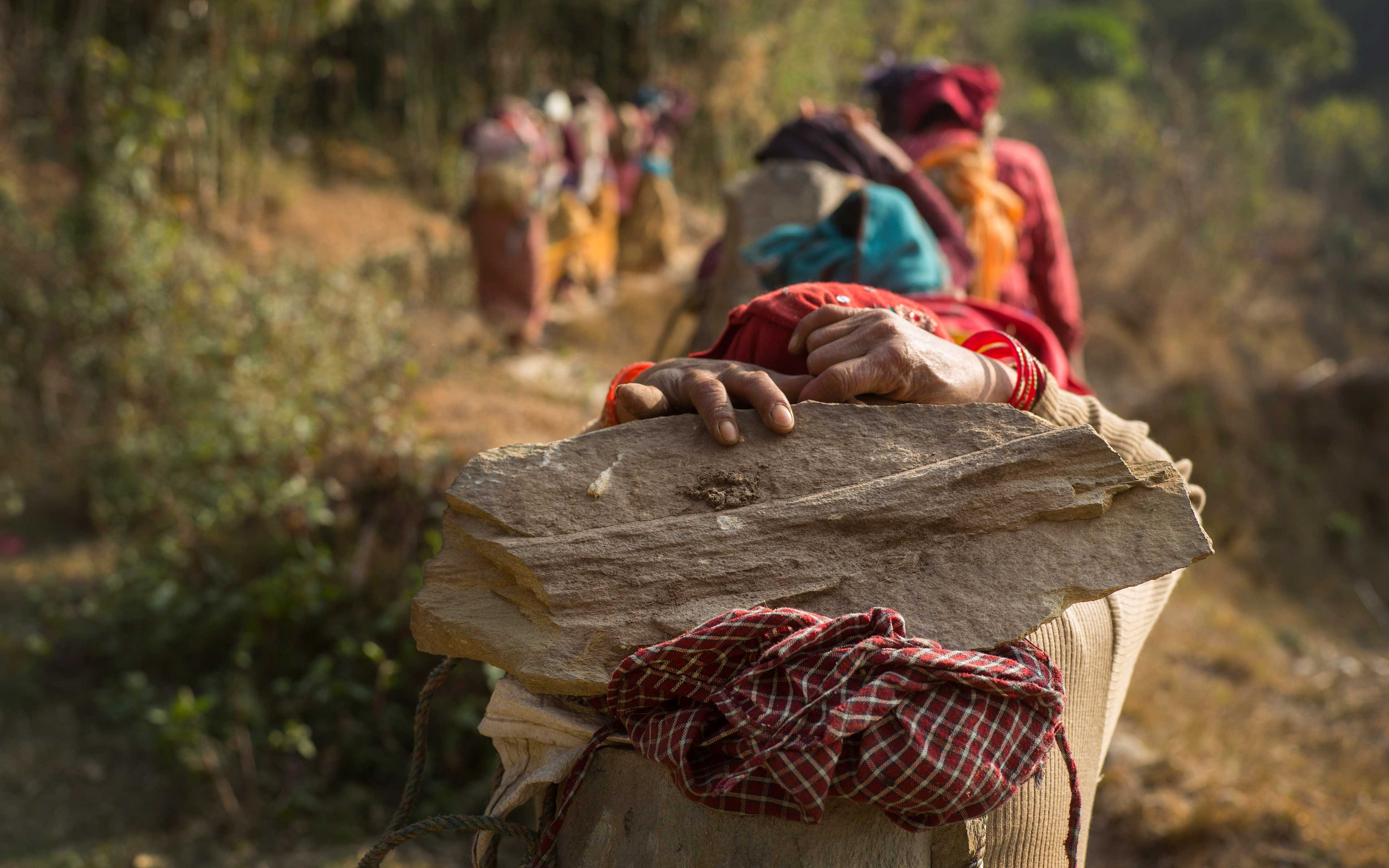 Community members living in Ghairung, Ghorka take part in a cash-for-work initiative to rebuild a three-mile trail. The trail connects two villages, a health center, and a local market in Nepal. It will benefit 1,140 households.