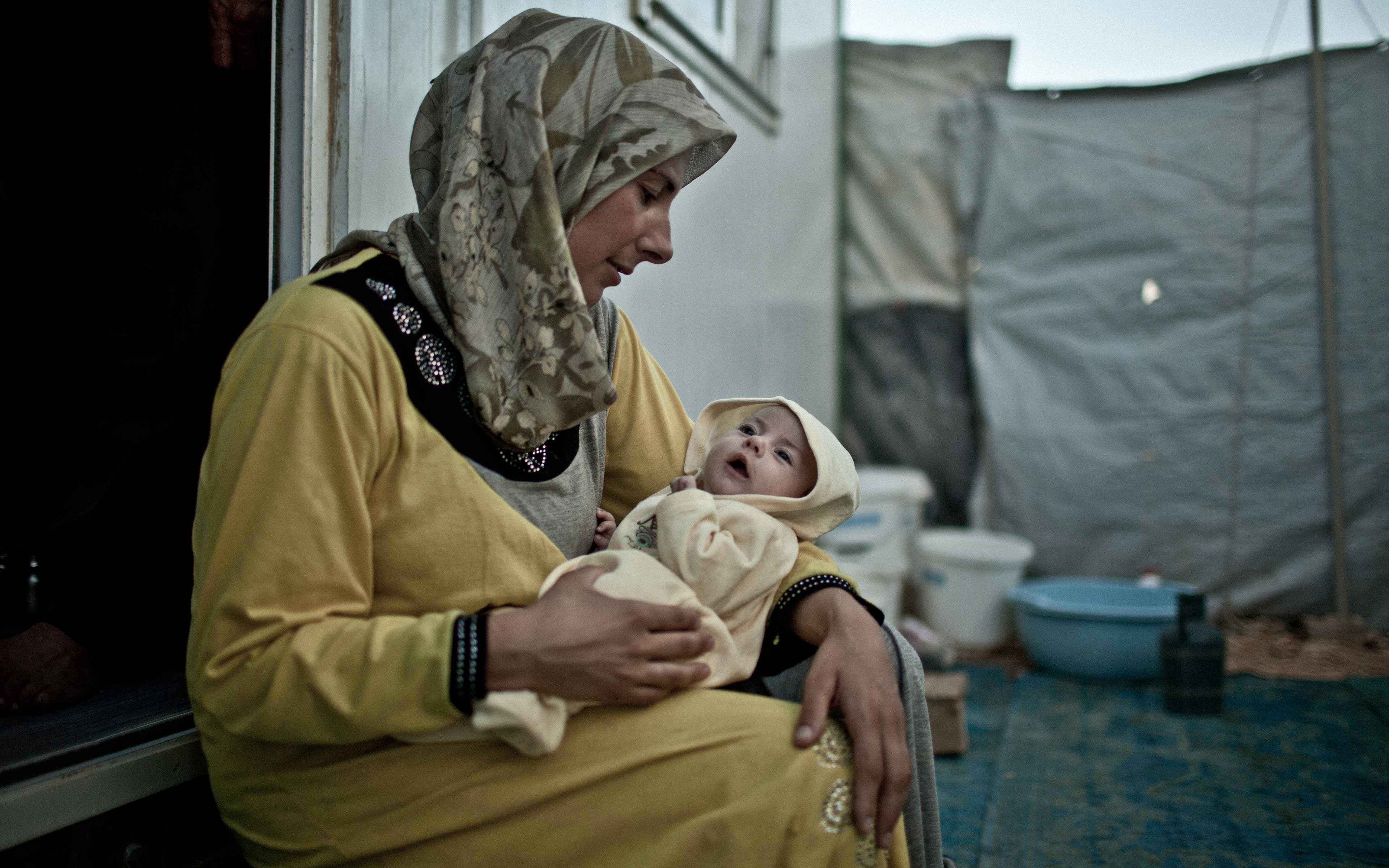 “This is a place built in the middle of the desert where the only thing these
people have are their caravans,” says photographer Pablo Tosco of the Zaatari refugee camp in Jordan. Nefel Nasser sits on a caravan step.
“They lost their homes, the playgrounds where their children played, the schools, the hospitals. ... right now they are in this kind of mourning limbo,” adds Tosco.