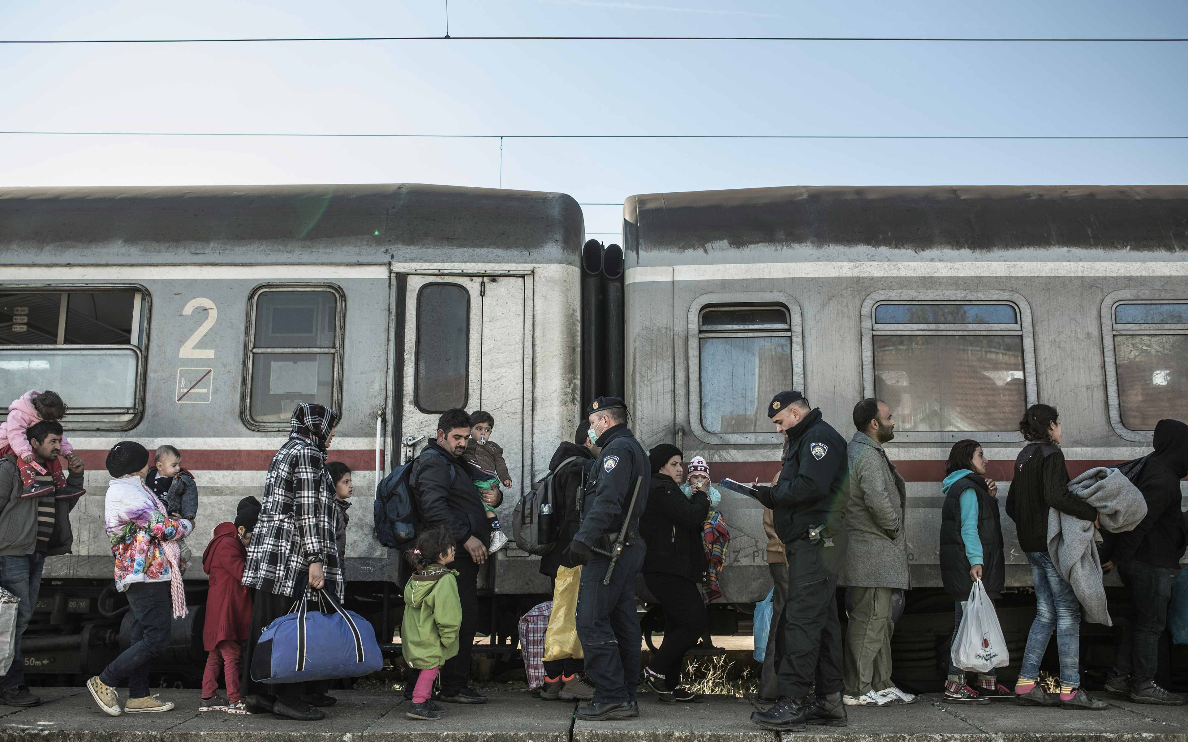 Refugees wait at a train station in Sid, Serbia.